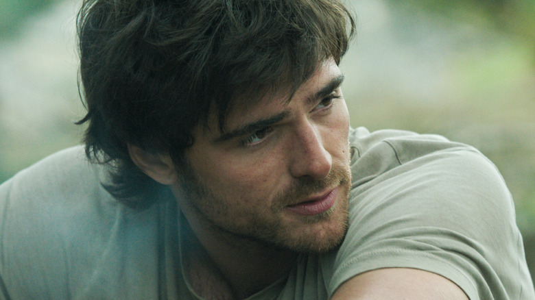 Jacob Elordi as Hig looking to his left while sitting in The Dog Stars