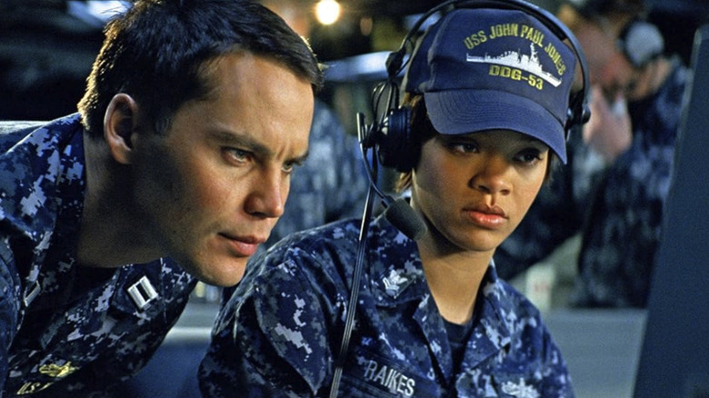 Rihanna's Cora Raikes wearing camo and looking at a monitor in Battleship