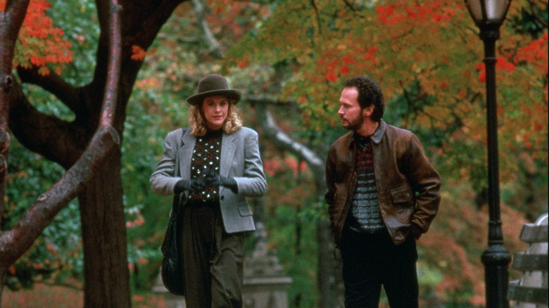 Sally in a hat jacket and gloves and Harry in a brown jacket walking in Central Park in When Harry Met Sally...