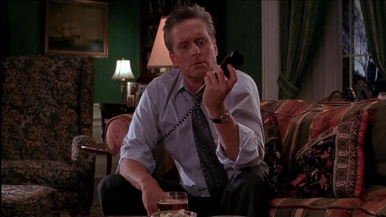 Andrew looking at a phone in confusion in The American President