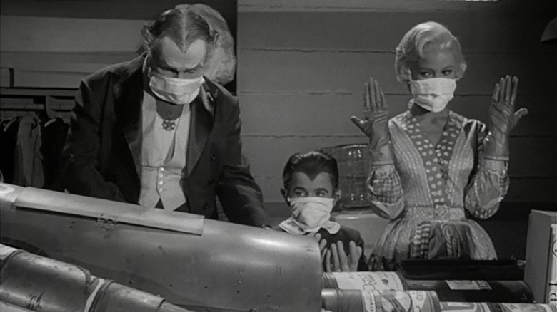 Grandpa Dracula, Eddie Munster, and Marilyn Munster making the Tin Can Man
