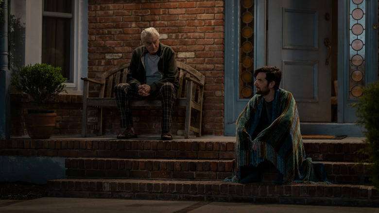 Robert De Niro's Peter Willis sits on his porch with Adam Scott's Tom Kennedy in The Whisper Man