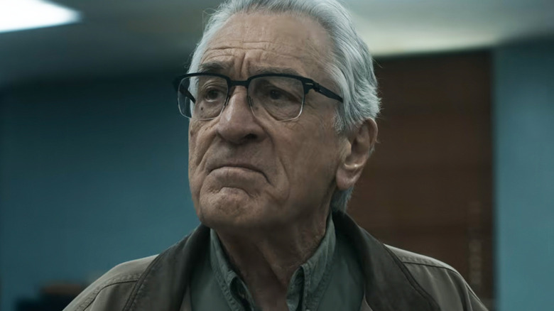 Robert De Niro's Peter Willis is seen in closeup as he stands in a police station in The Whisper Man.jpg