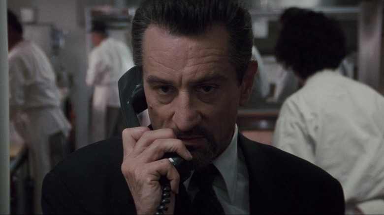 Robert De Niro as Neil McCauley talking on the phone in the kitchen in Heat