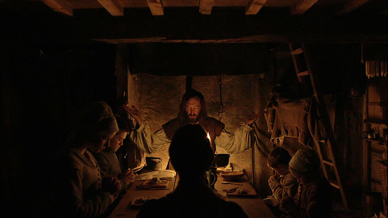 The family prays at the dinner table
