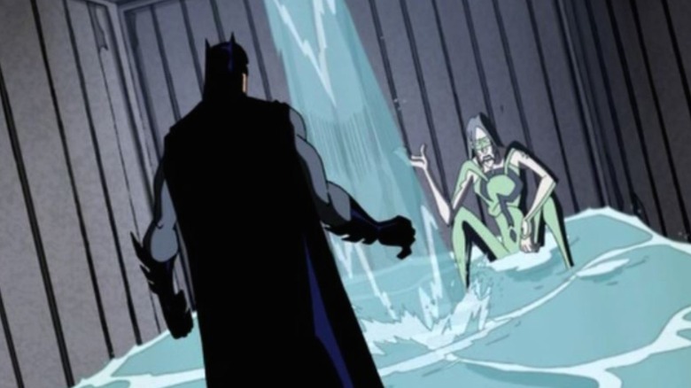 Batman and Riddler in flooding shipping crate