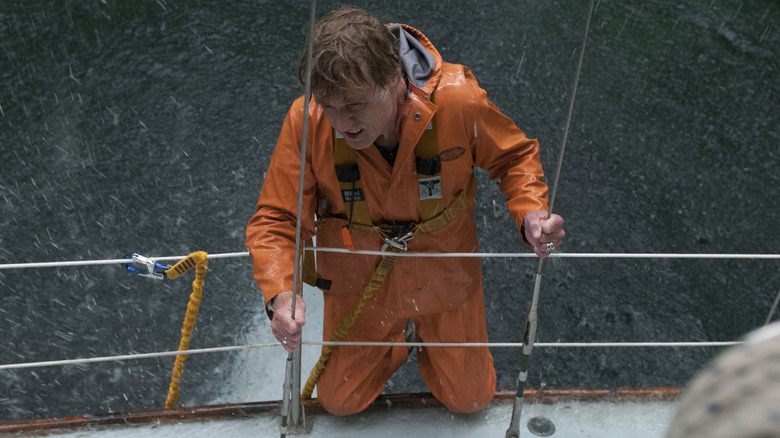 Robert Redford as 'Our Man' holding onto his ship during a storm in All Is Lost