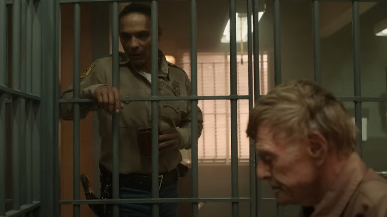 Zahn McClarnon as Joe Leaphorn watches Robert Redford as a prisoner play chess in Dark Winds