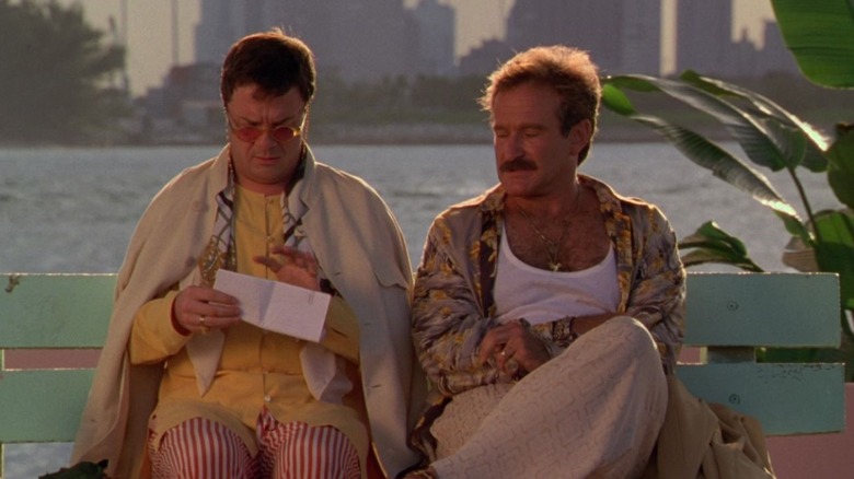 Albert (Nathan Lane) and Armand Goldman (Robin Williams) sit together on a bench by the water in The Birdcage
