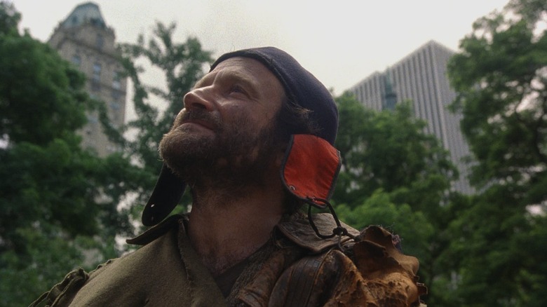 Parry (Robin Williams) looks up stoically in Central Park in The Fisher King