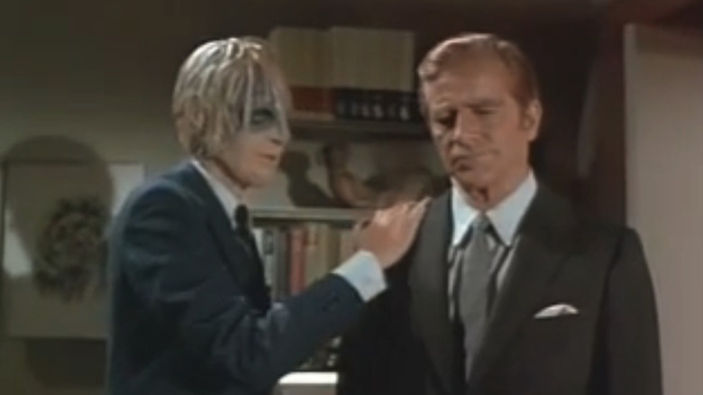 Jon Korkes' Victor Koch puts his hand on the shoulder of Dana Andrews' Paul Koch in Night Gallery