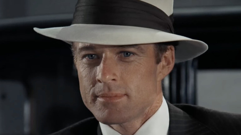 Robert Redford wearing a hat and smiling as Jay Gatsby in The Great Gatsby (1974)