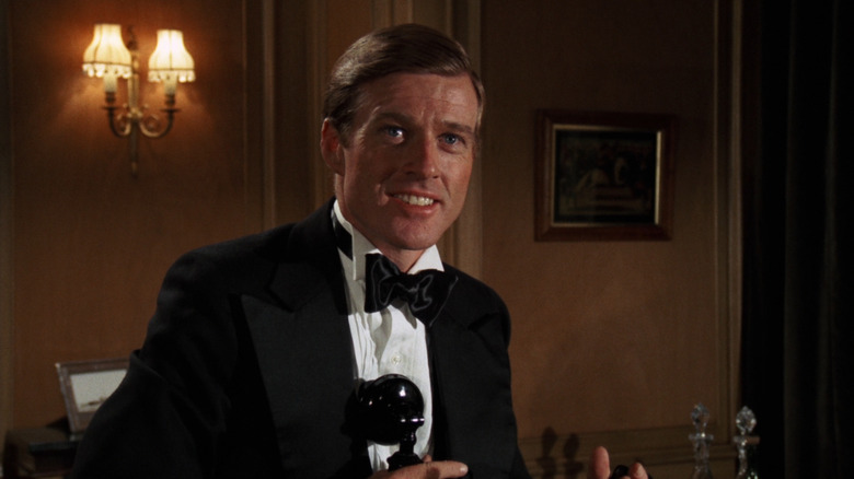 Robert Redford wearing a tuxedo and grinning as Jay Gatsby in The Great Gatsby (1974)