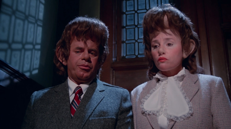 Jerry Lewis' Wilbur Swain / Caleb Swain stands beside Madeline Kahn's Eliza Swain / Letitia Swain in Slapstick of Another Kind
