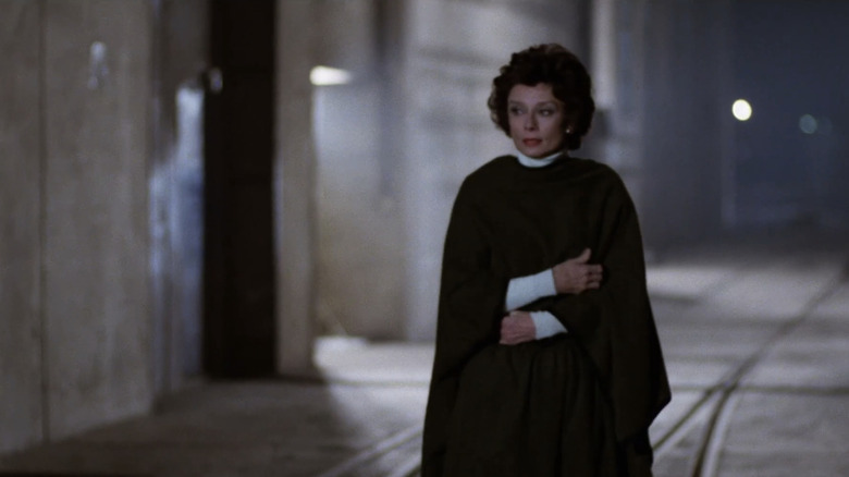 Audrey Hepburn's Elizabeth Roffe crosses her arms as she stands on a street in Bloodline