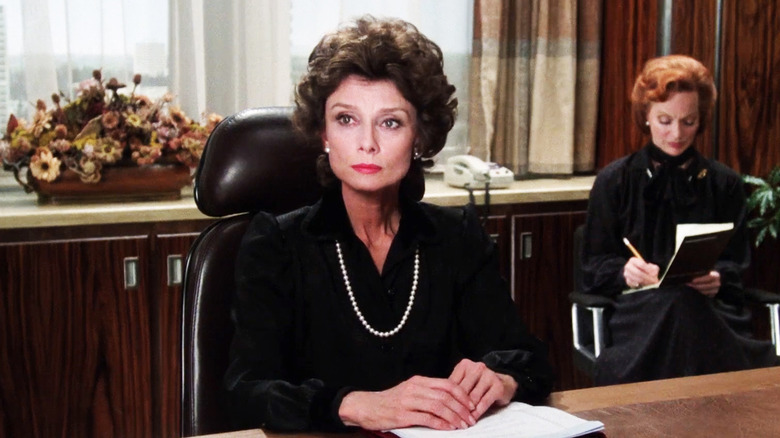 Audrey Hepburn's Elizabeth Roffe looks stern as she sits at a desk in Bloodline