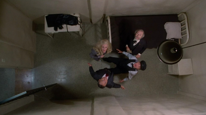 A group of people seen from the ceiling of an asylum cell in High Anxiety