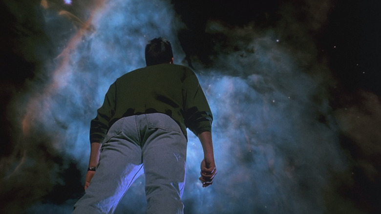 A person looking up into outer space in The Arrival