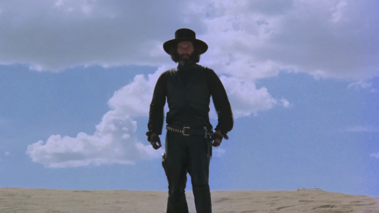 Alejandro Jodorowsky as El Topo stands in a desert in El Topo