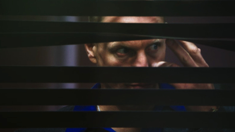 Woody Harrelson's David Brown peers through some blinds in Rampart