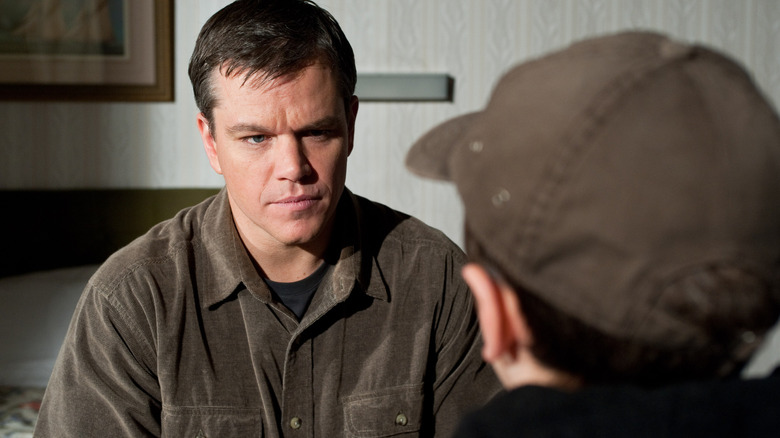 George Lonegan talking to a boy in a ballcap in Hereafter