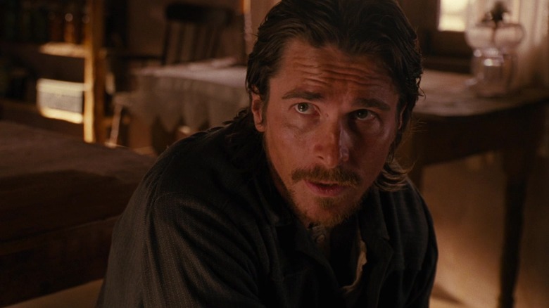 Christian Bale as Dan Evans looking up in concern in 3:10 to Yuma