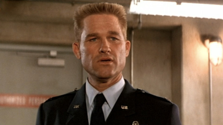 Kurt Russell's Jack O'Neill stands in uniform in closeup in Stargate