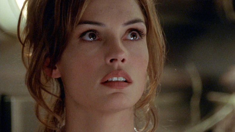 Famke Janssen as Trillian St. James looking up at something scary in Deep Rising