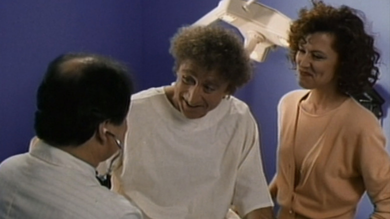 Gene Wilder's Duffy Bergman sits on a doctor's table alongside Christine Lahti's Meg Lloyd Bergman in Funny About Love
