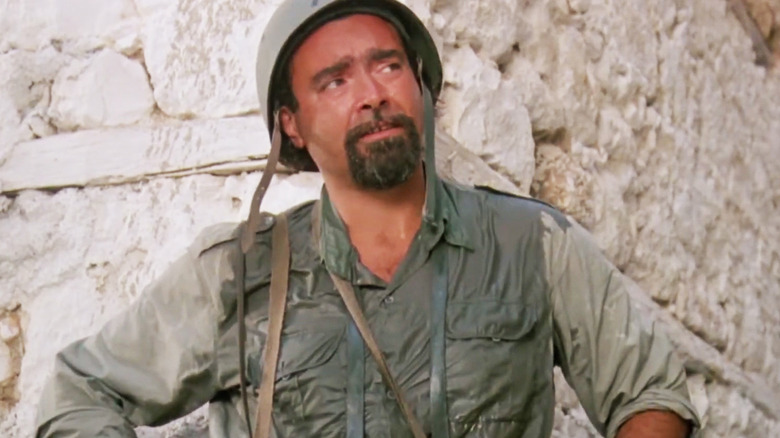 Diego Abatantuono's Sgt. Nicola Lo Russo stands against a wall looking off to his left in Mediterraneo