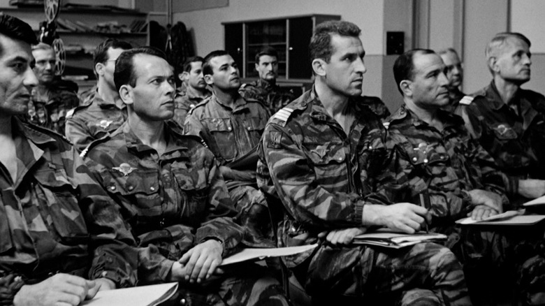 A group of men in camouflage uniforms sitting together in The Battle of Algiers