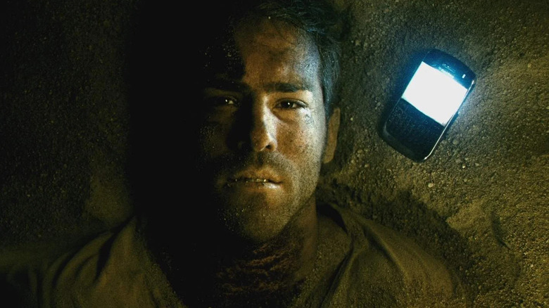 Paul Conroy trapped in a coffin, a phone by his head, in Buried