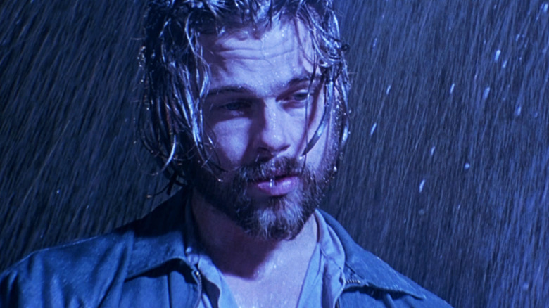 Brad Pitt's Early Grace stands in the rain in Kalifornia