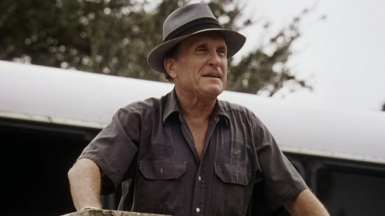 Robert Duvall's Euliss F. Sonny Dewey looks off into the distance as he stands outside in The Apostle