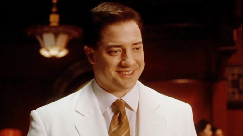 Brendan Fraser's Alden Pyle stands in a white suit in The Quiet American
