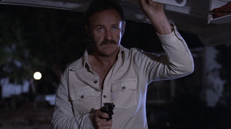 Gene Hackman wields a handgun as Harry Moseby in Night Moves