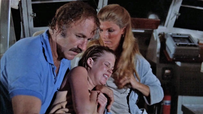 Gene Hackman as Harry Moseby and Jennifer Warren as Paula comfort Melanie Griffith as Delly Grastner in Night Moves