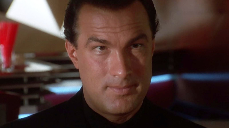 Casey Ryback in a shadowy room in Under Siege 2: Dark Territory