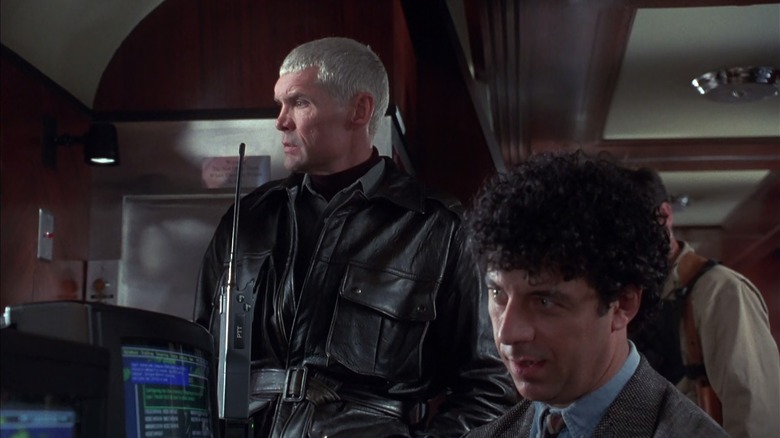 Marcus Penn standing next to Travis Dane, a computer villain, in Under Siege 2: Dark Territory