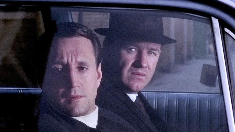 Roy Scheider as Buddy "Cloudy" Russo and Gene Hackman as Popeye Doyle peer out from their unmarked police cruiser in The French Connection