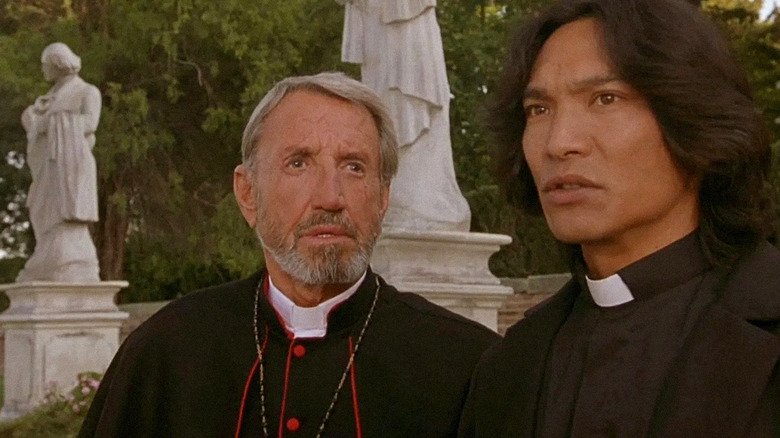 Cardinal Siqueros (Roy Scheider) and Father Uffizi (Jason Scott Lee) stand in a graveyard in Dracula II: Ascension