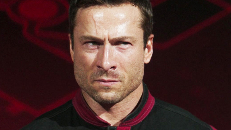 Glen Powell's Ben Richards is seen looking intense in closeup in The Running Man
