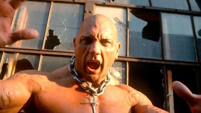 Bautista Leviathan character posing in front of broken windows on WWE television