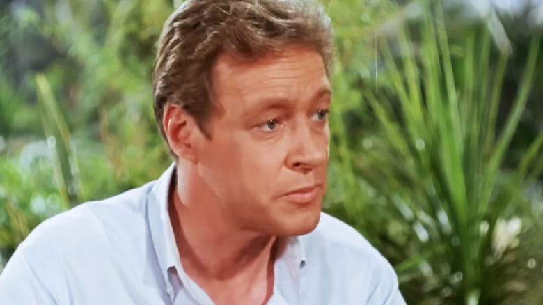 Russell Johnson's Professor Roy Hinkley is seen against a background of shrubbery in Gilligan's Island