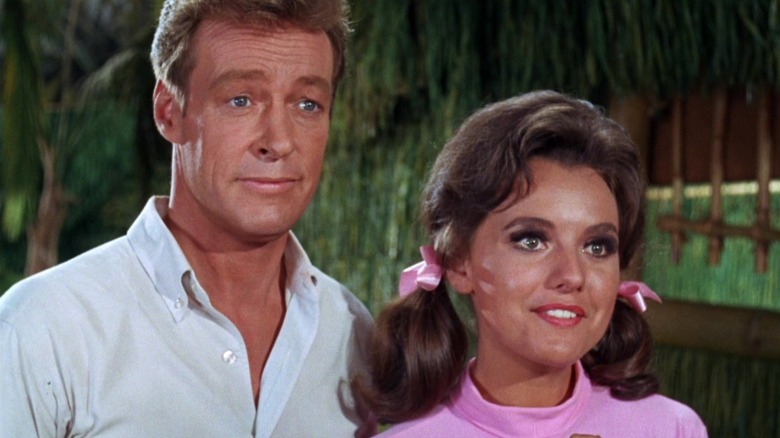 Professor and Mary Ann stand side by side, friendly air on the island of Gilligan