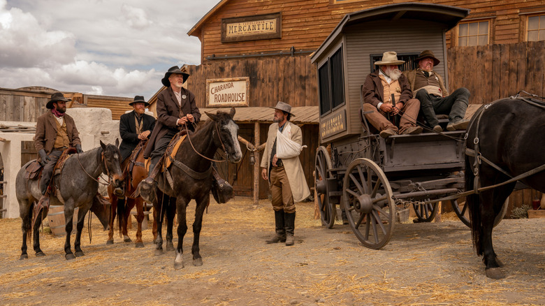 A group of cowboys gathered together on horseback in Rust