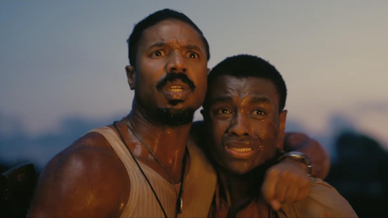 Michael B. Jordan's Stack and Miles Caton's Sammie looking at something in horror in Sinners