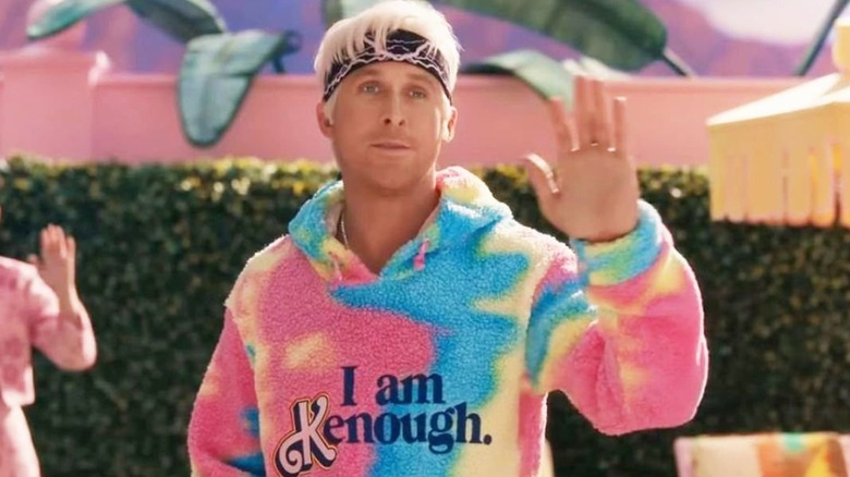 Ken waving wearing his I Am Kenough sweatshirt in Barbie