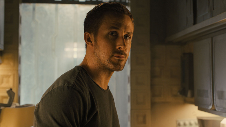 Ryan Gosling as K standing in his apartment in Blade Runner 2049