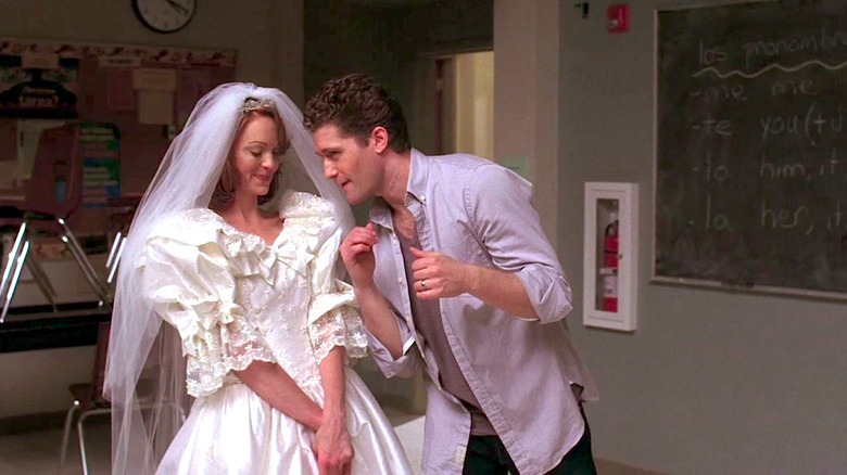 Jayma Mays watches as Matthew Morrison dances and sings on Glee